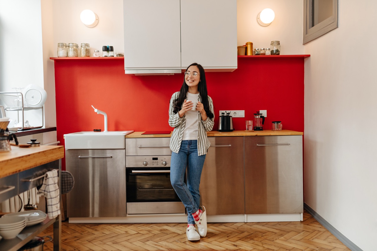 joyful girl in jeans and shirt is holding white cu 2026 01 05 01 14 47 utc Large