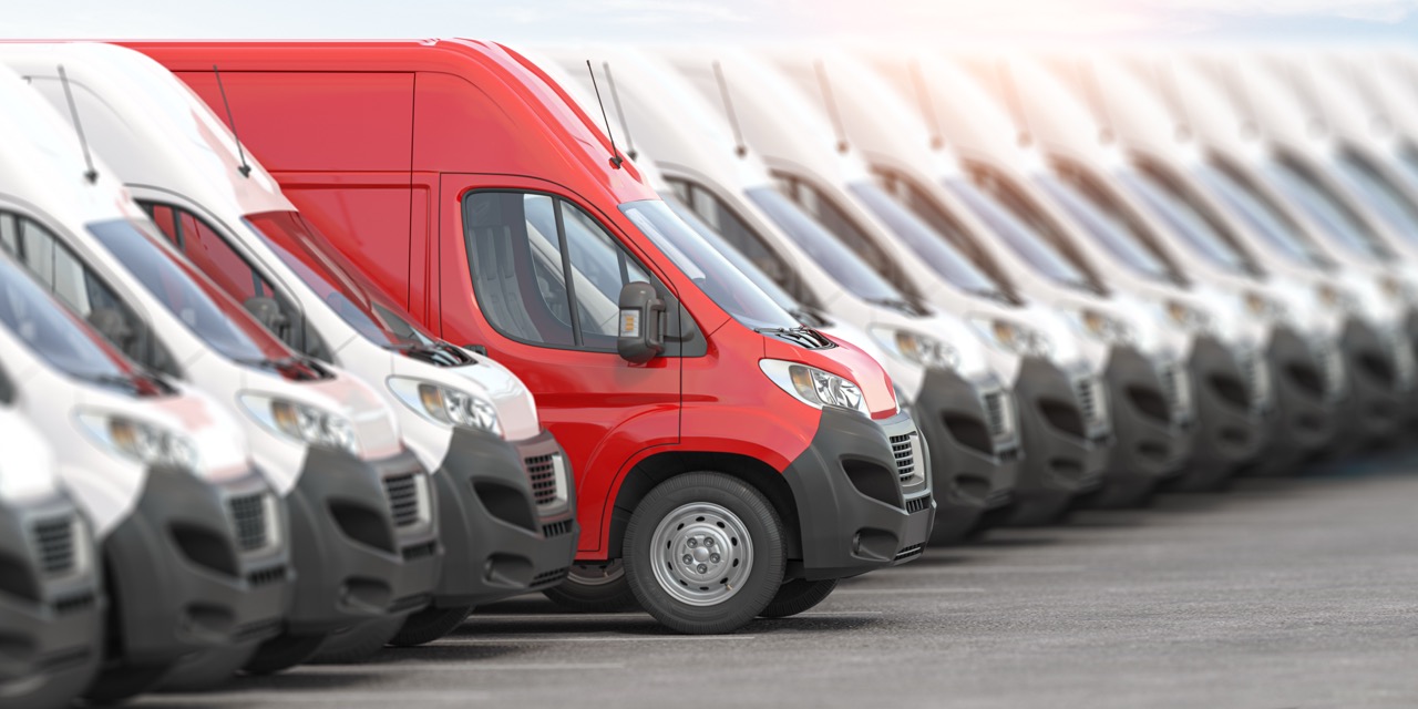 red delivery van in a row of white vans best expr 2026 03 24 07 30 05 utc Large